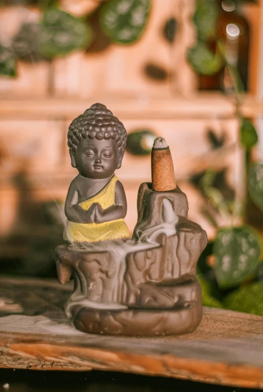 a statue of a boy holding a cigar next to a bottle