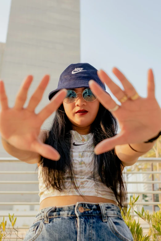 a woman that is standing up in front of her hands