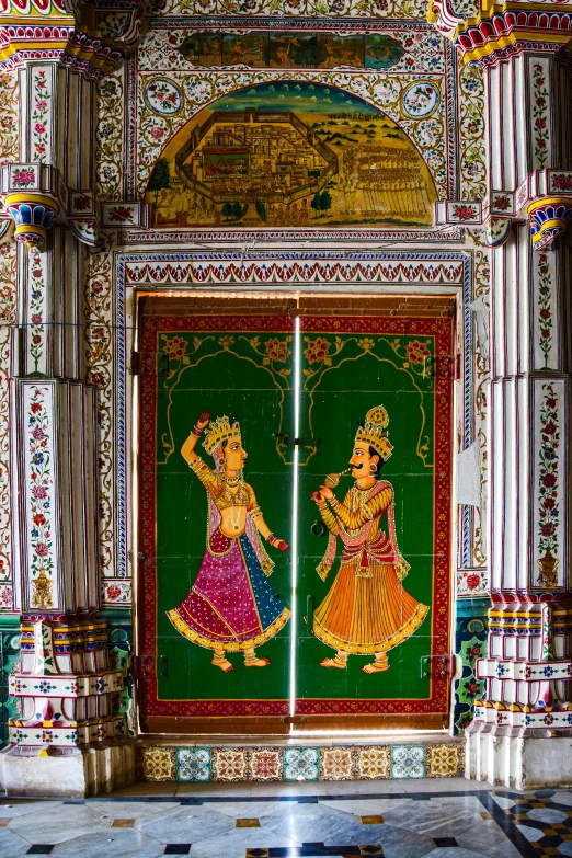 the colorful doors of an elaborate temple decorated with images