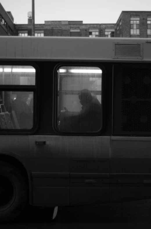 a person riding on the bus with his phone in hand