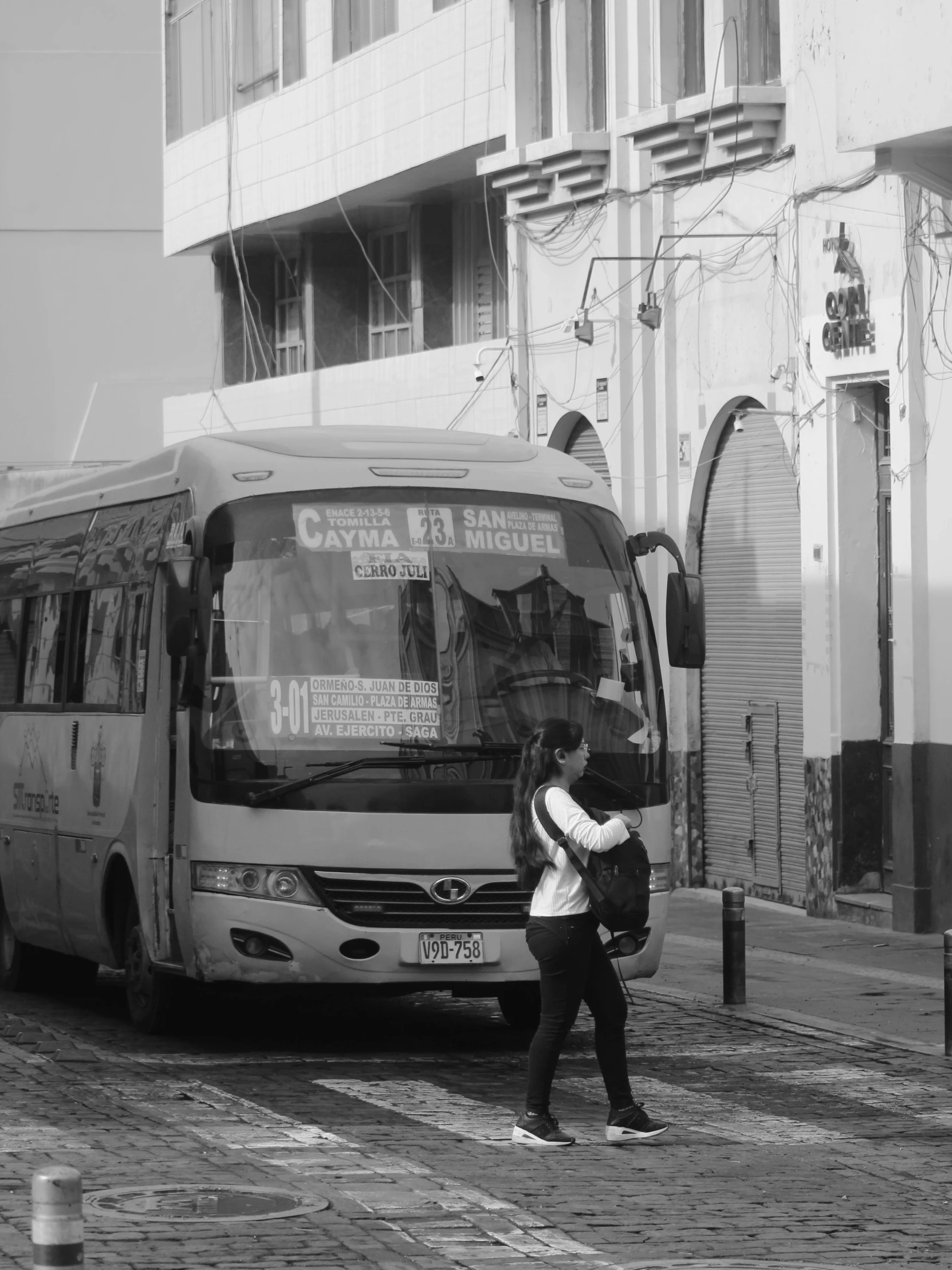 woman with an umbrella getting off a bus