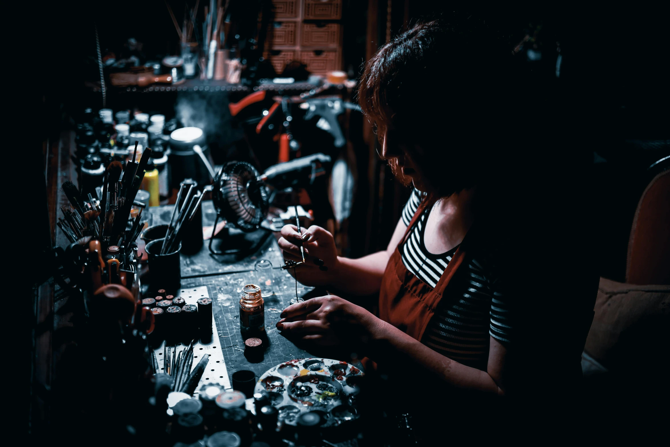 a woman is working on the front end of her bicycle