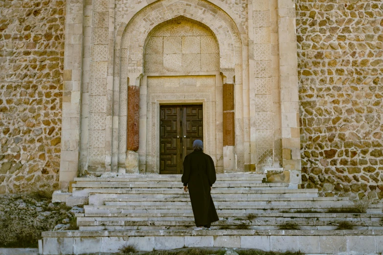 a man in black is walking towards a door and steps