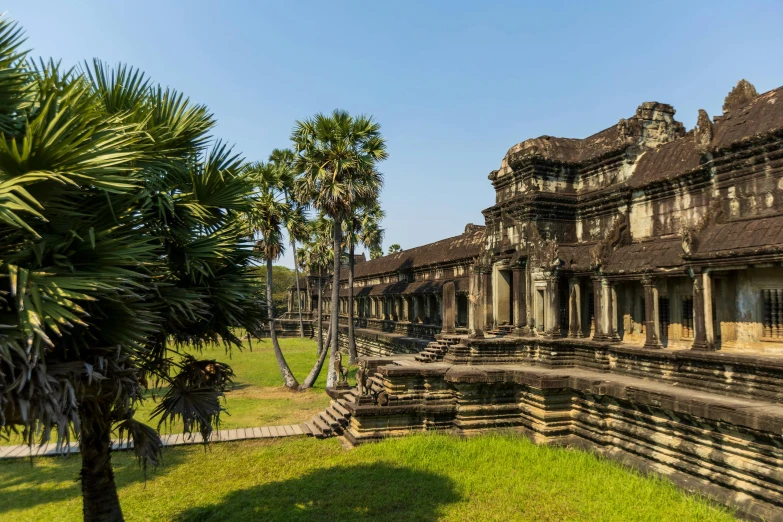 an elaborate building sits in the middle of a grassy area