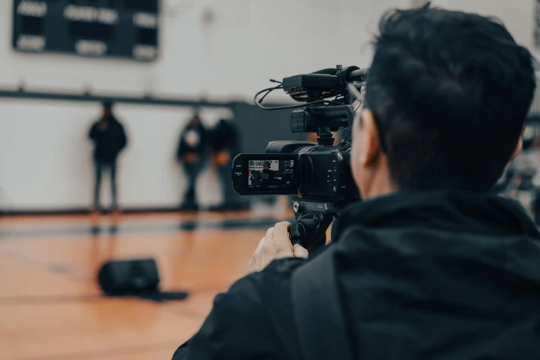 a man in black jacket and white shirt with a camera