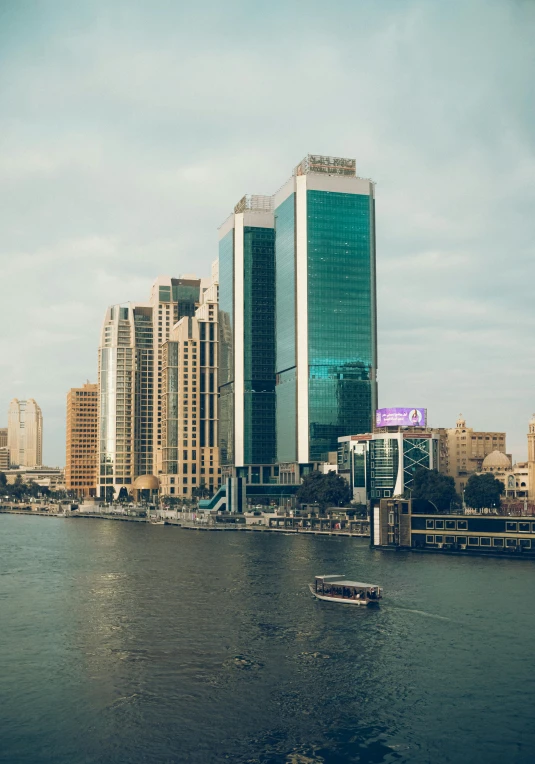 the city is reflected in the water of the river