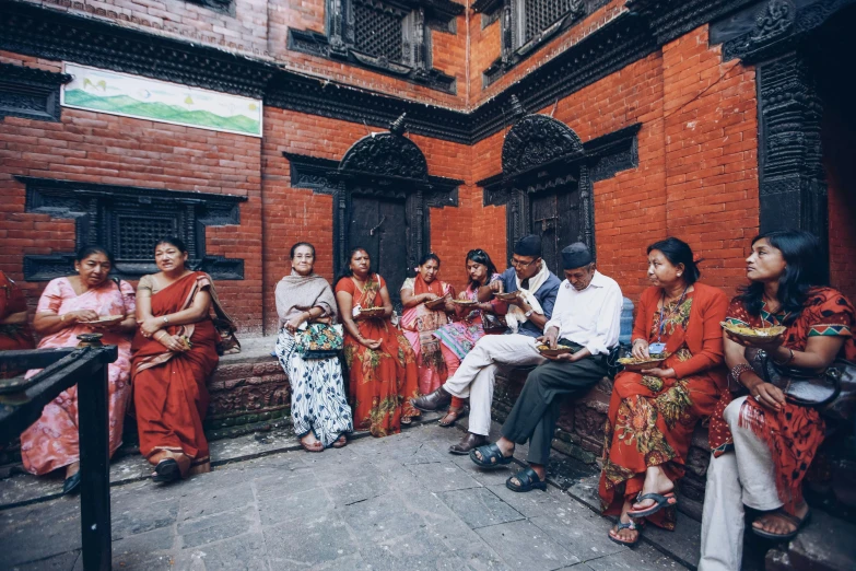 a group of people gathered outside in an alley