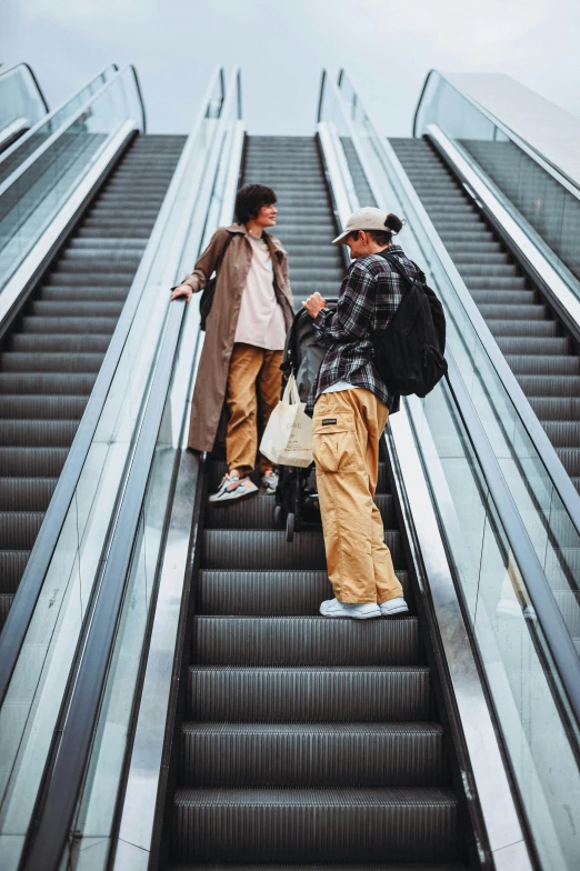 people riding down escalators in an airport