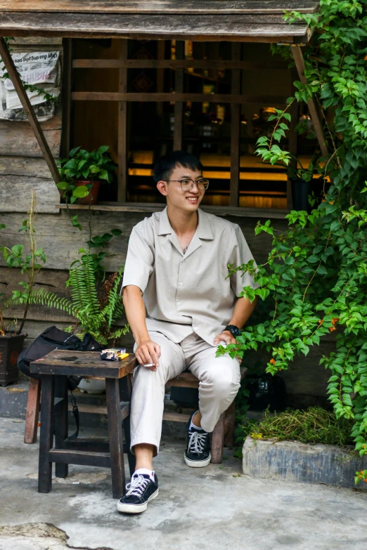 a person is sitting on a wooden bench