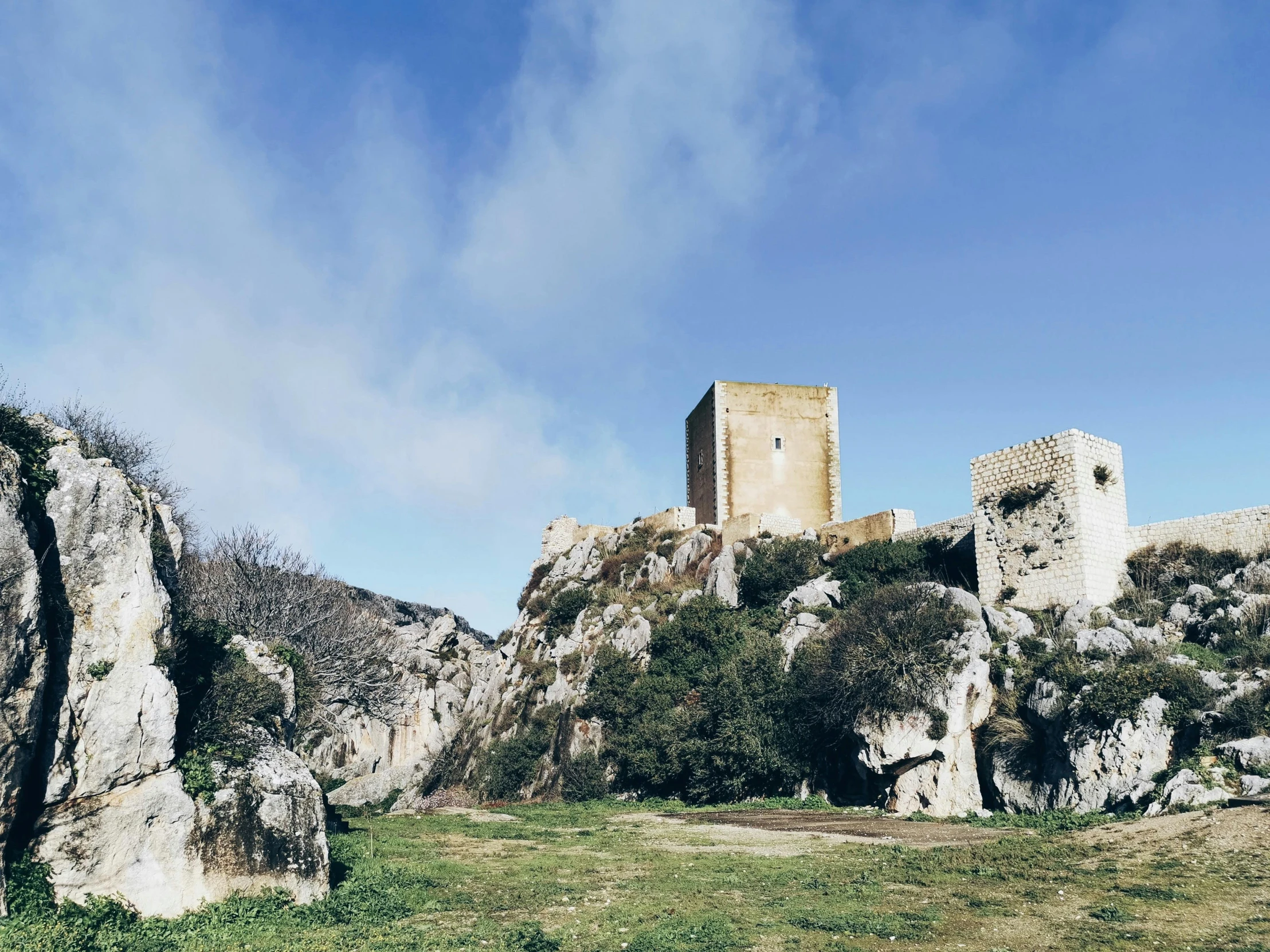 there is an old stone castle on a hillside