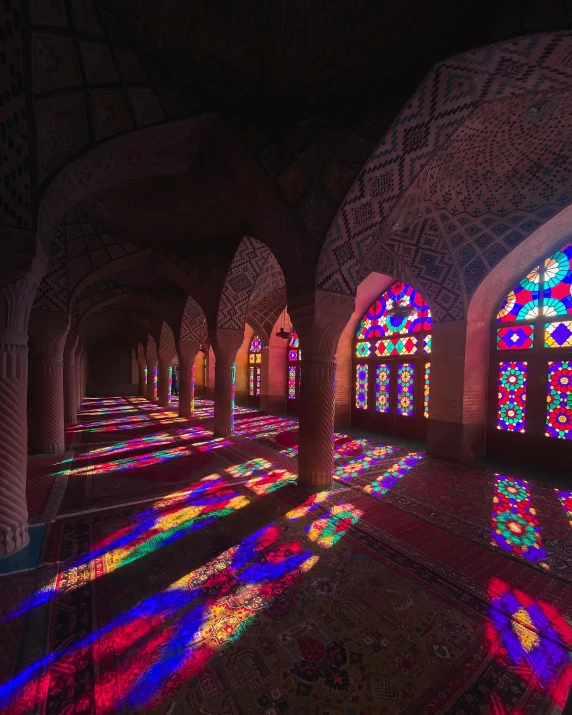 stained glass windows in a large building lit by lights