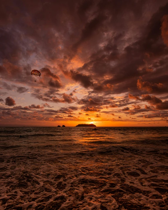 sunset with kites in the sky on the beach