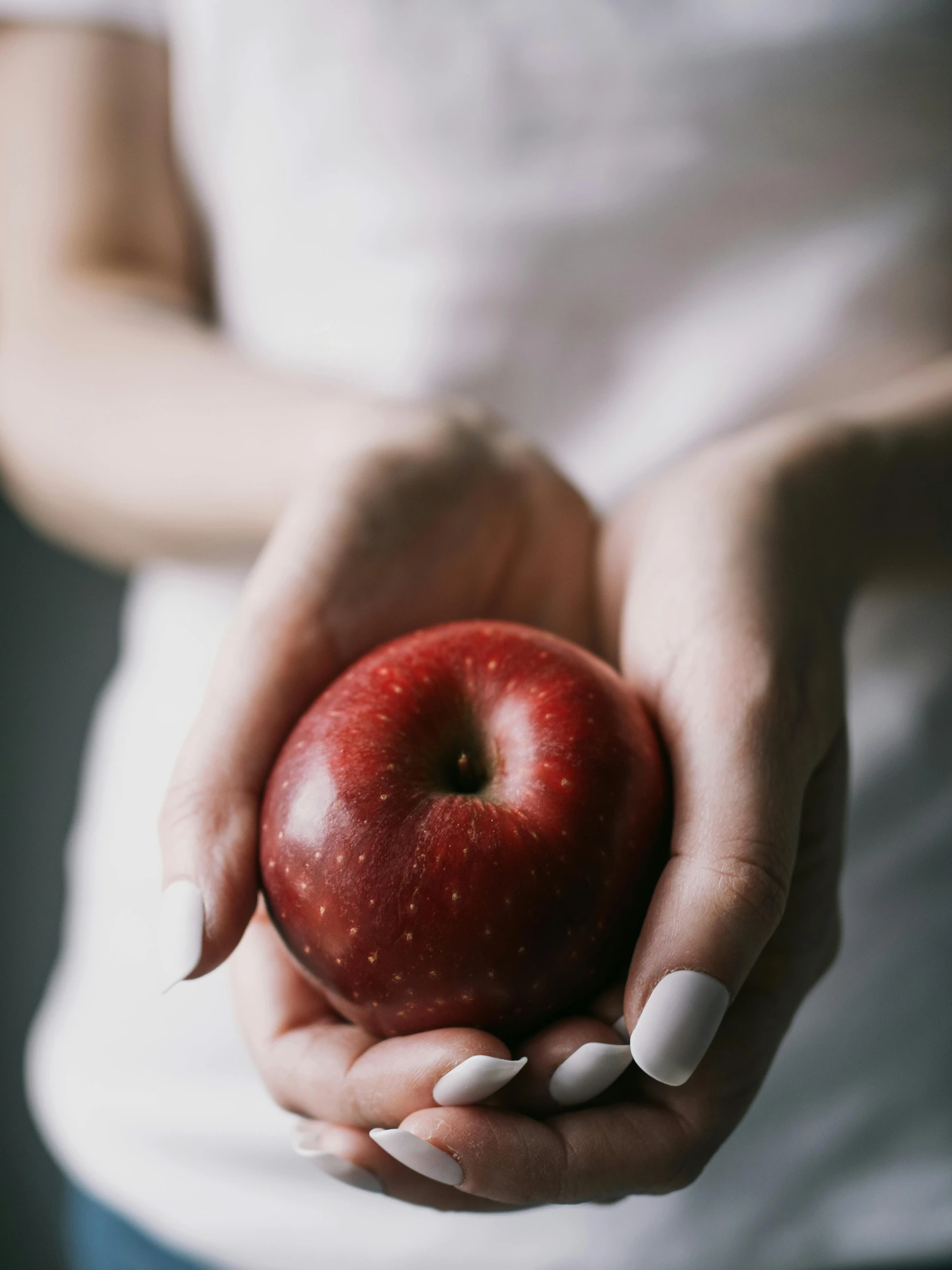 a woman holding an apple in her hands