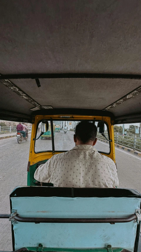 a man riding in the back of a small truck