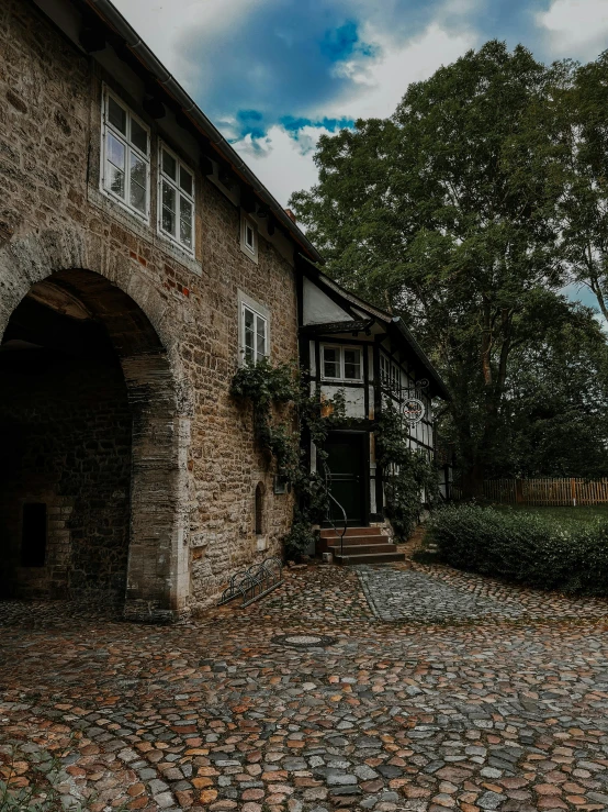 a cobble stone driveway has a door open