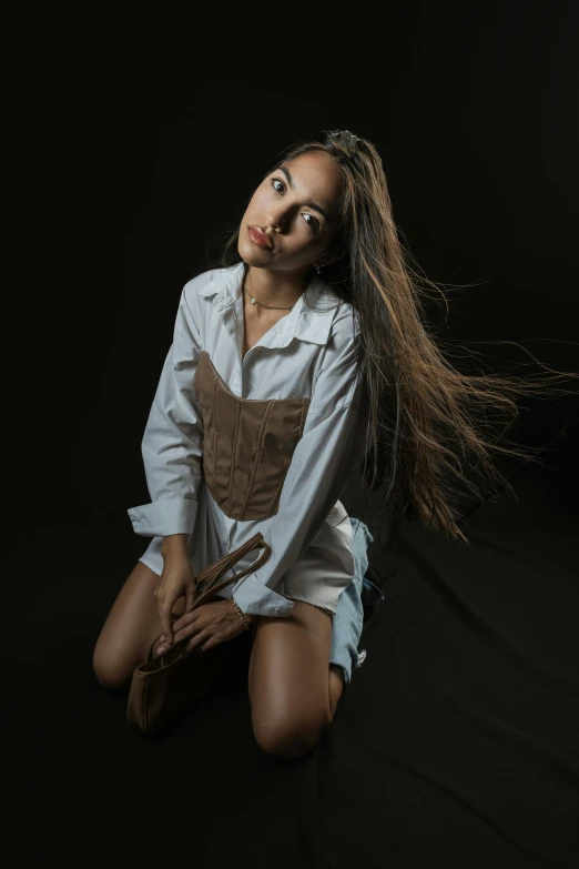 a person is sitting with her hair blowing