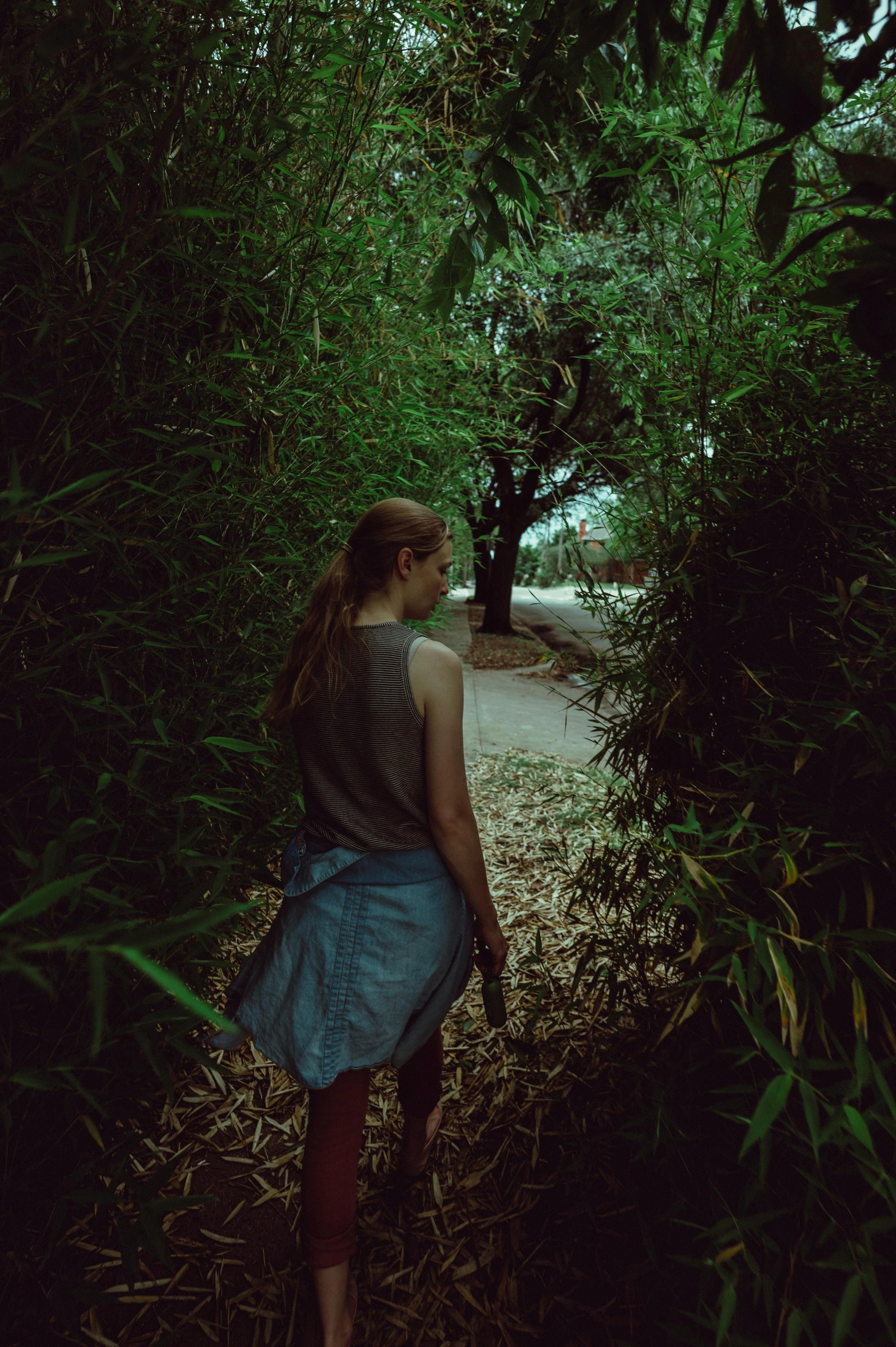 a woman in a park under some trees