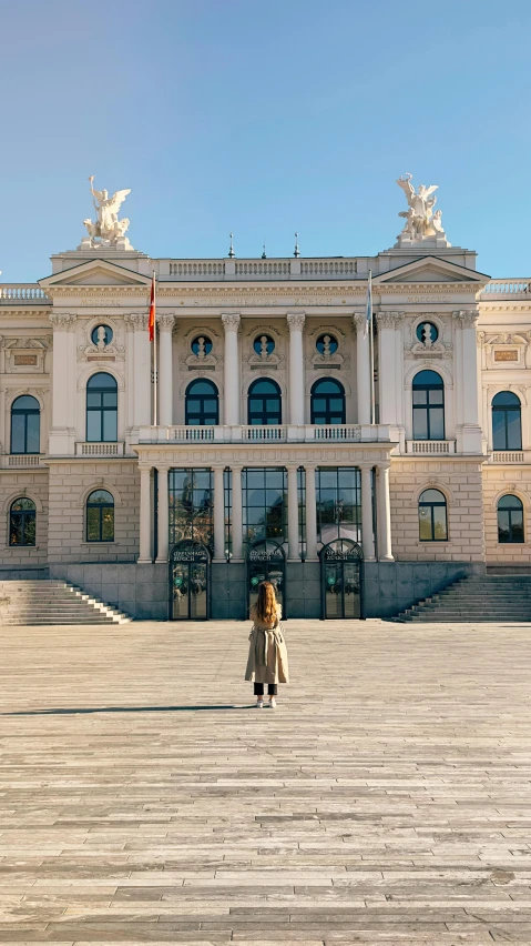 a woman is standing on steps outside of a building