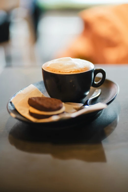 cup of coffee with a spoon on a saucer