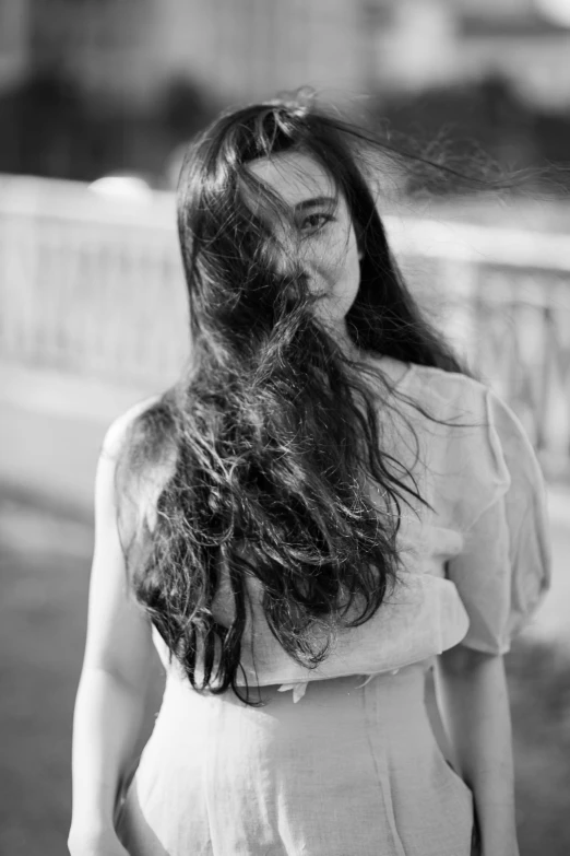 a young woman standing in a park looking up