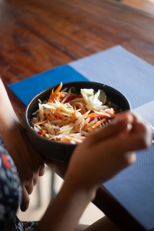 there is a woman holding a bowl of food