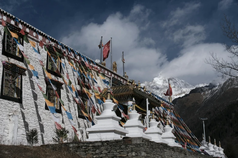 a stone building that is decorated with some kites hanging off of it