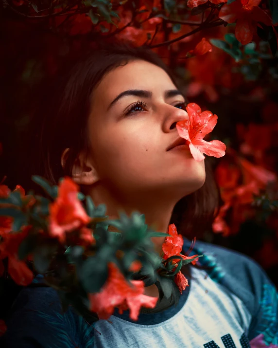 a woman wearing a flowered necktie in front of flowers