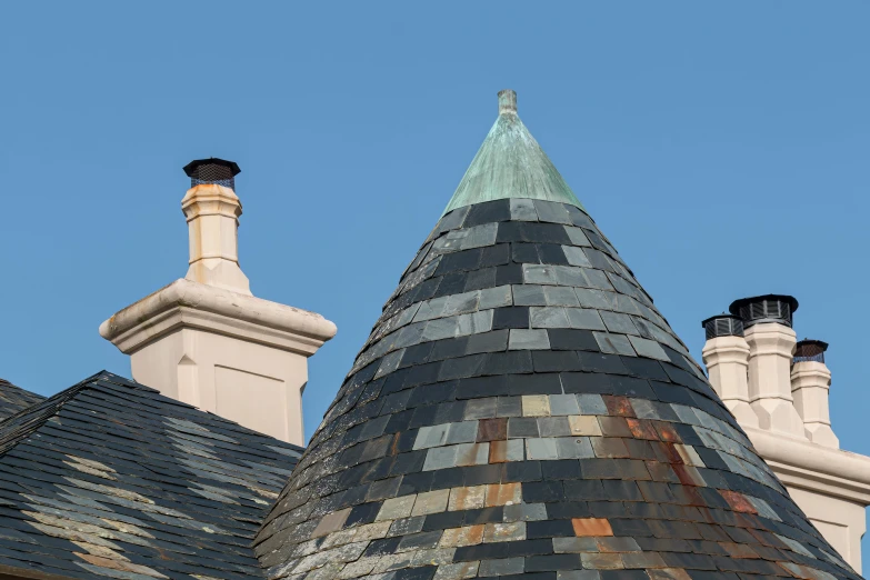 two chimneys are in the background of a blue sky