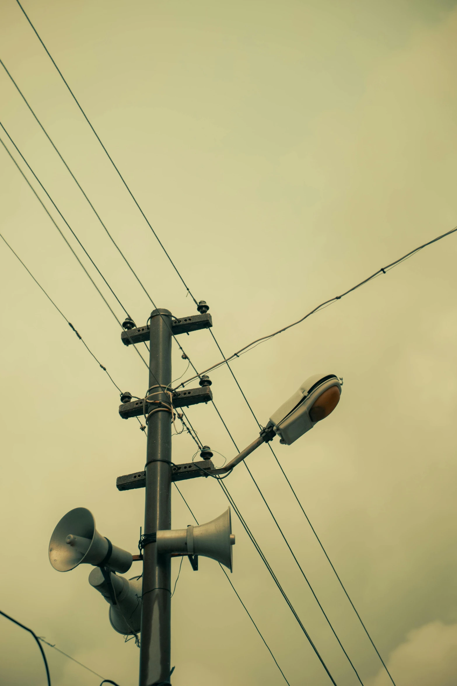 telephone pole with traffic lights next to electrical wires and telephone towers