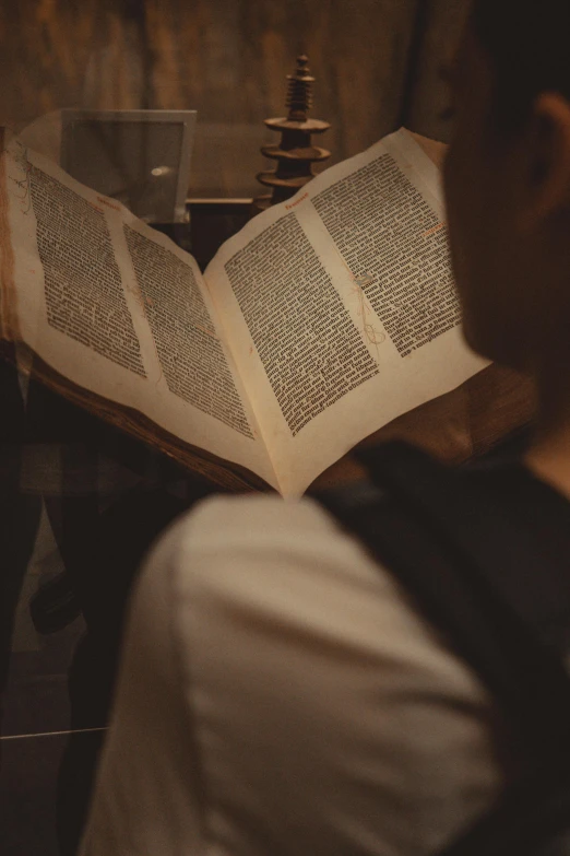 a man reading a book on the table