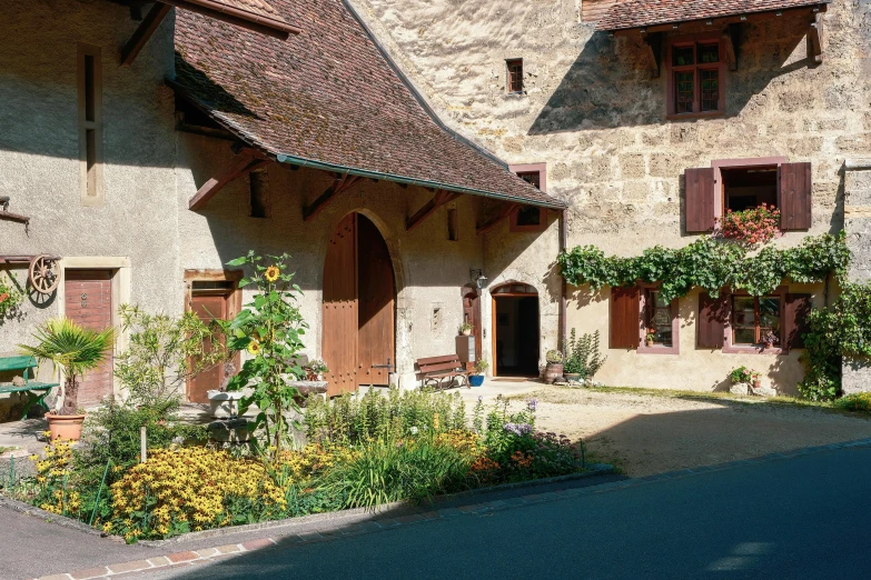 a small house with red trim on the roof and windows