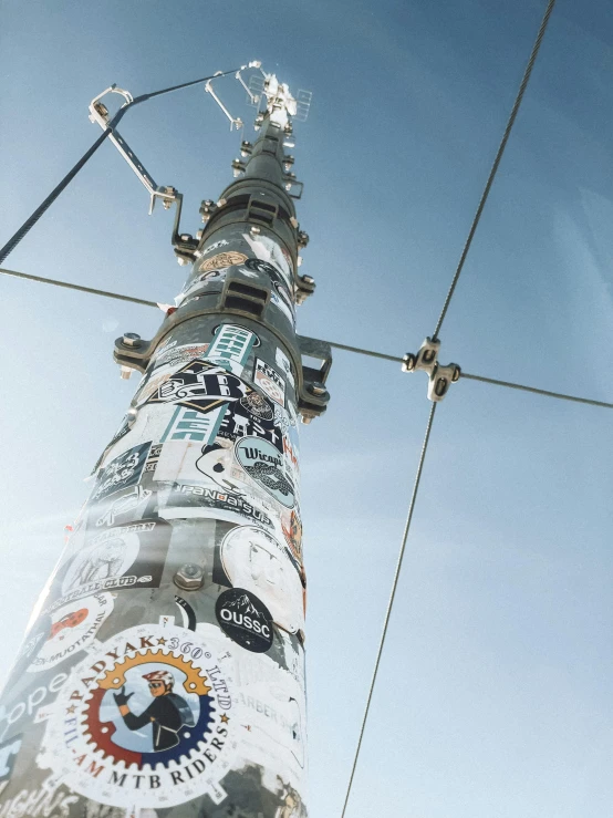 there is a very tall pole covered in advertits