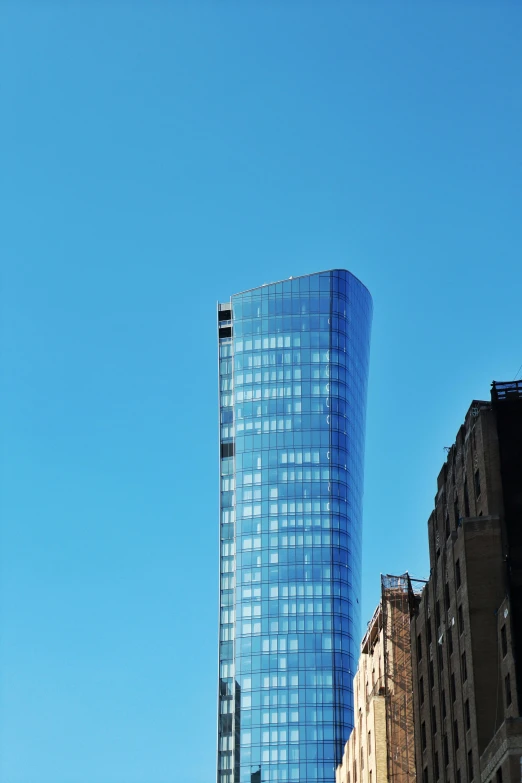 a very tall building with glass windows in the city