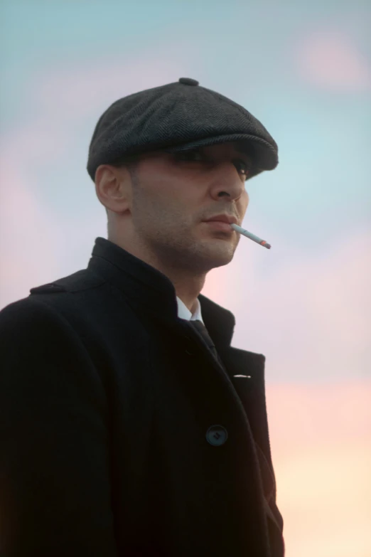 man with cigarette in mouth standing on beach