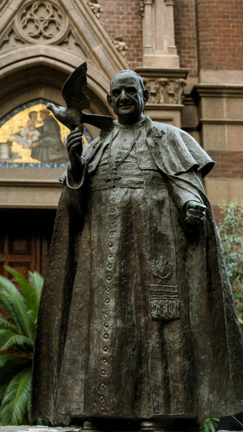 a bronze statue is in front of a building