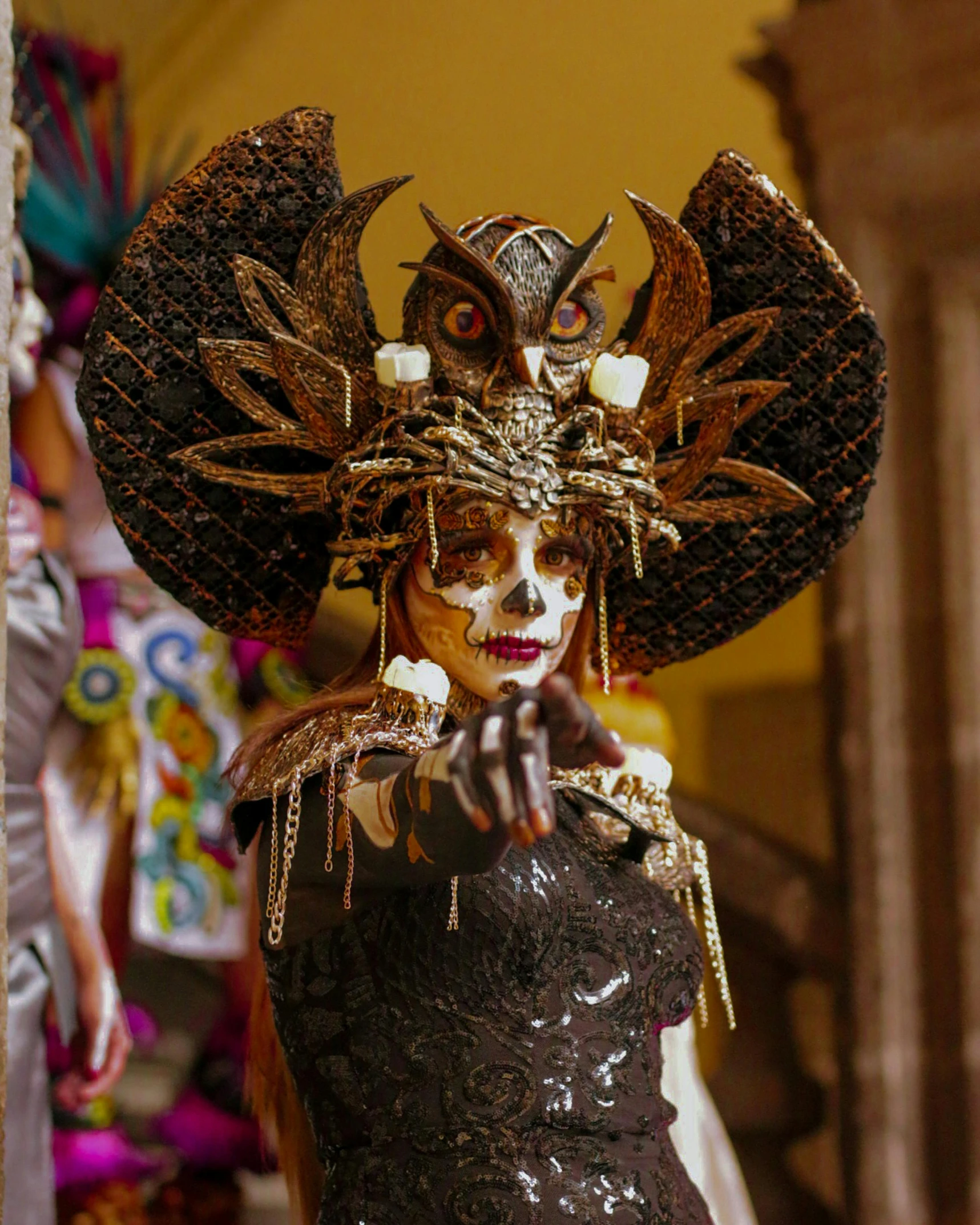 a woman wearing a headpiece while standing next to a wall