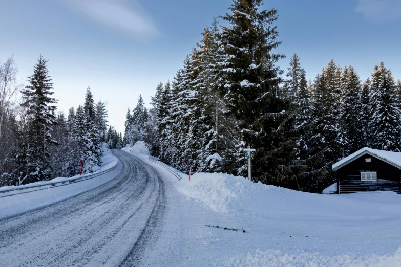 a country road has snow on the side of it