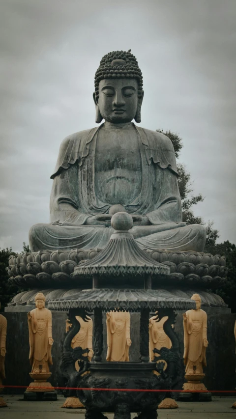 buddha statue in front of a stone shrine