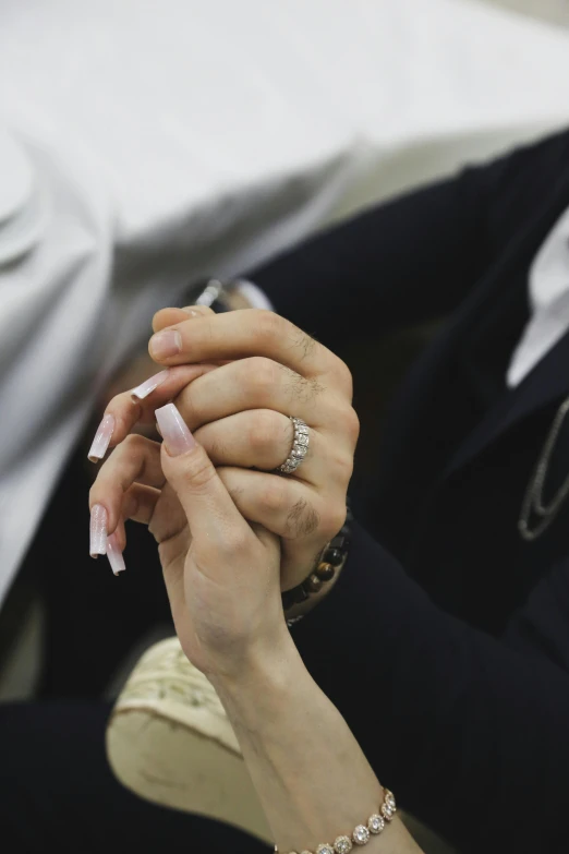 a man with a ring on holding his finger