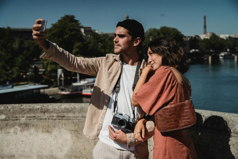 a man and woman taking a po on a cellphone