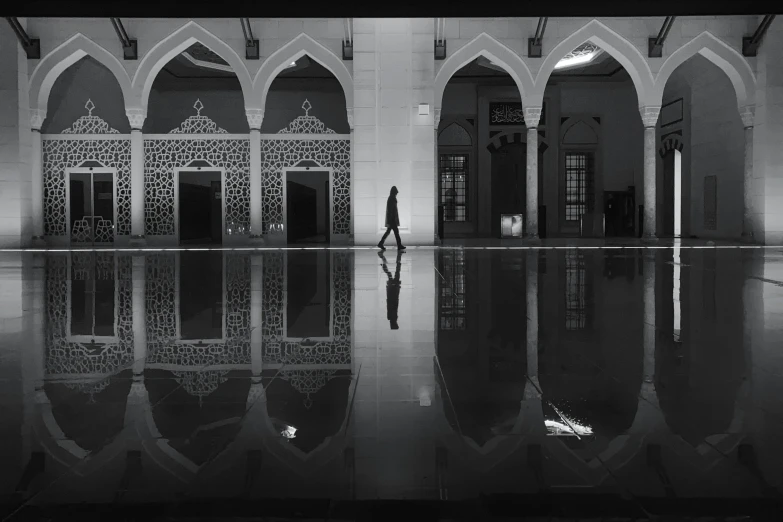 a person in a building stands in the middle of a floor