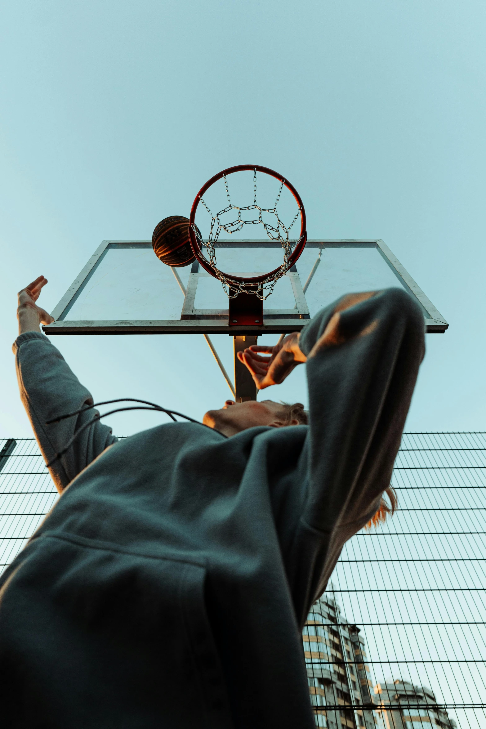 a man playing basketball is looking up into the sky