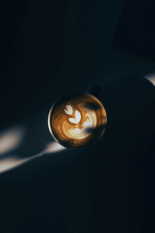 a cup of coffee with heart shapes drawn in the foam