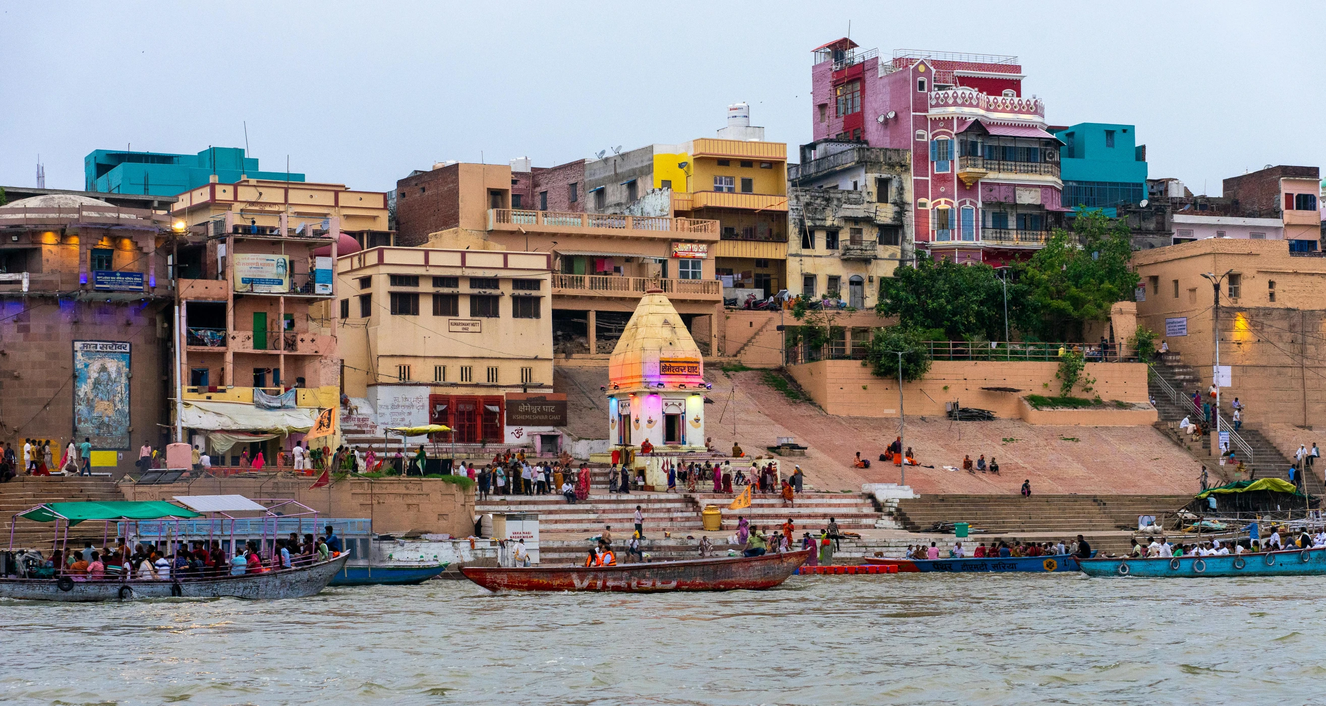 many boats sit in the water near houses