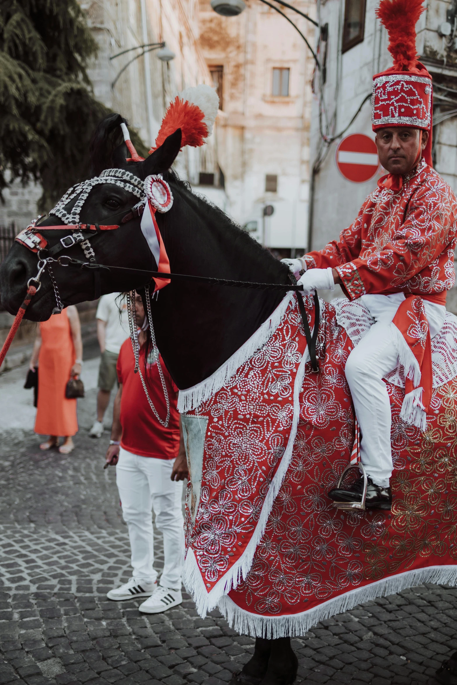 a person is riding a horse in a red and white dress