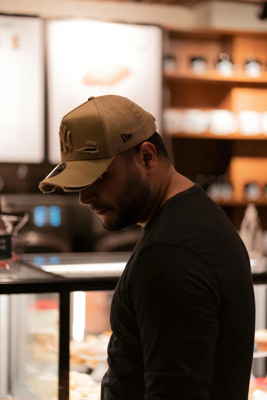 a man standing in front of a bakery counter