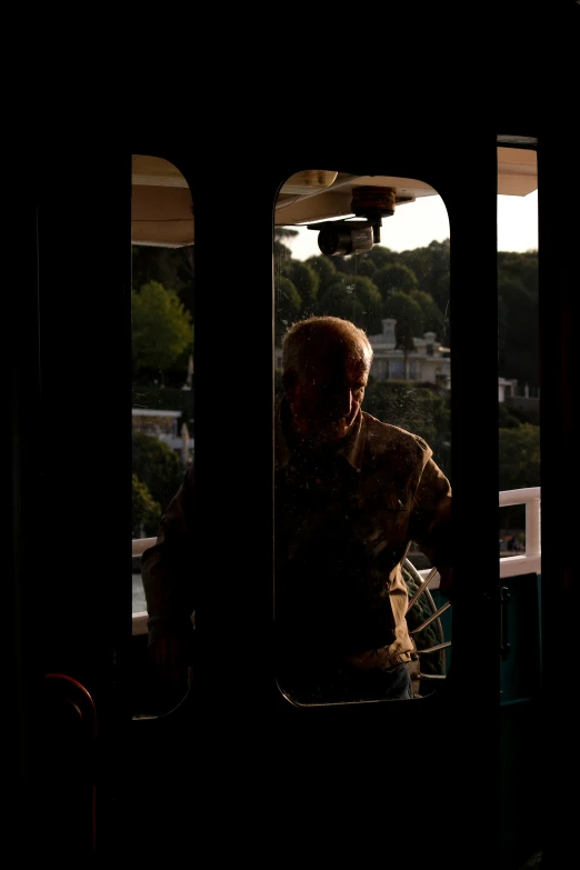 two men in a train window at sunset