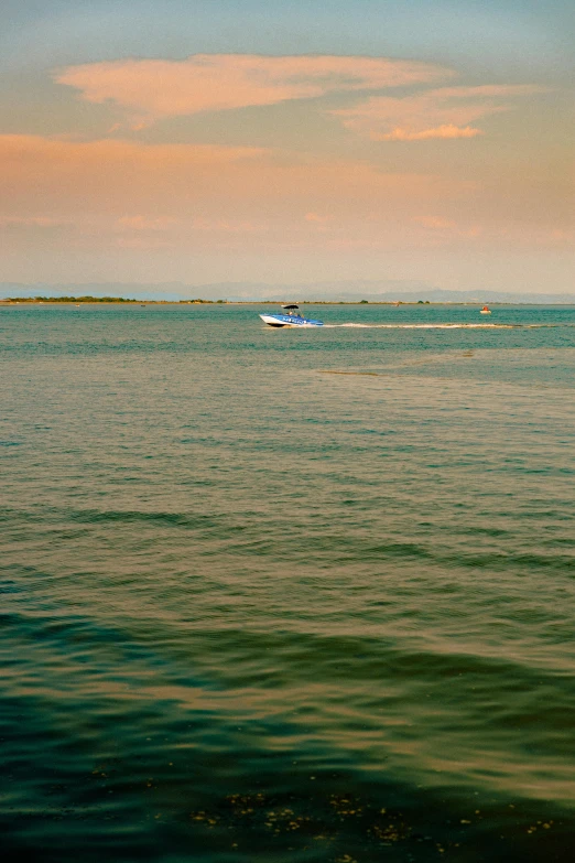 people sailing on a motorboat near the ocean