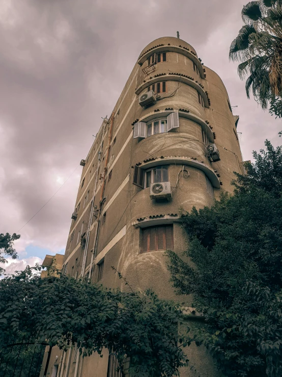 a tall building in the middle of a tree line