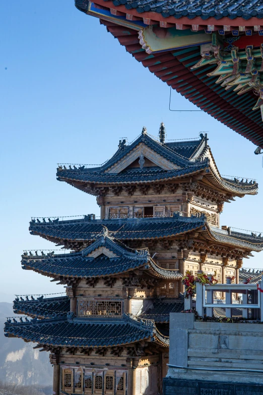 tall tower structure with blue roof tiles and two clock